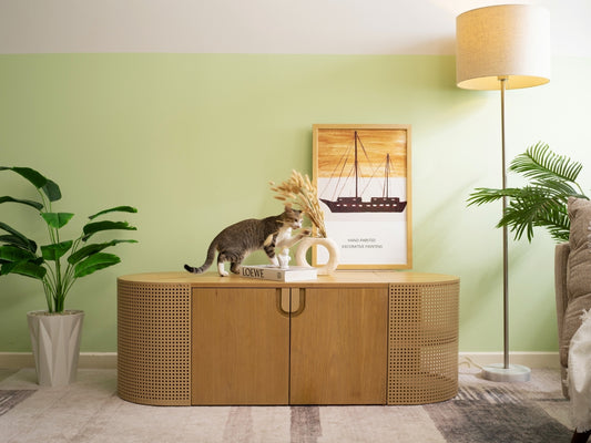 (Light) A spacious large litter box enclosure in a modern living room setting, with a playful cat on top, demonstrating the chic and multifunctional design of cat furniture