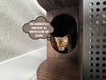 Cargar la imagen en la vista de la galería, (Dark) Close-up of a kitten peeking through the large entry of a chic black cat litter box cabinet, emphasizing ease of access and privacy
