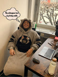 Cargar la imagen en la vista de la galería, Person working from home in a stylish and comfy wearable blanket hoodie with a snug cat pocket.
